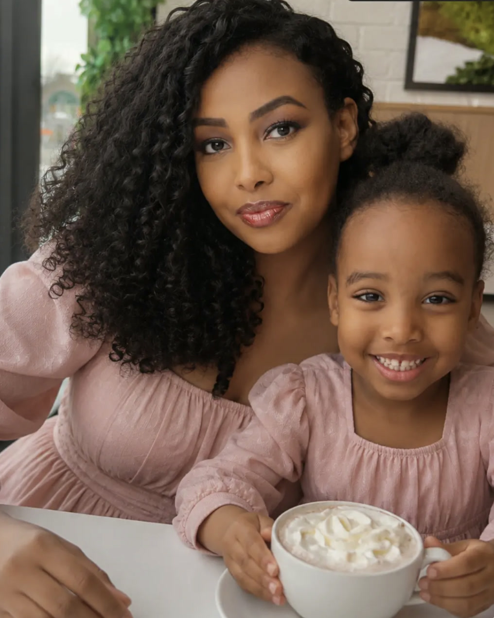 Qali Ahmed with her daughter sharing a hot chocolate