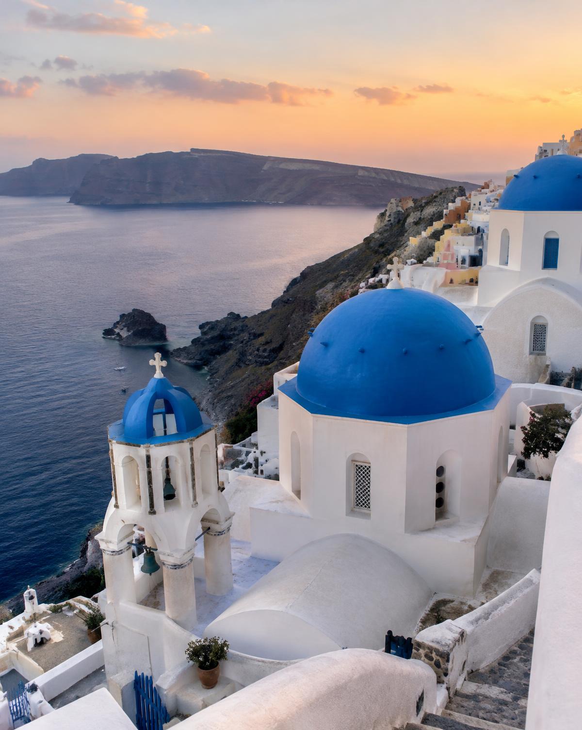 White buildings with blue domes overlooking the sea in Santorini